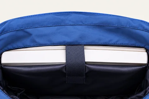 Padded interior laptop compartment with a retaining strap.