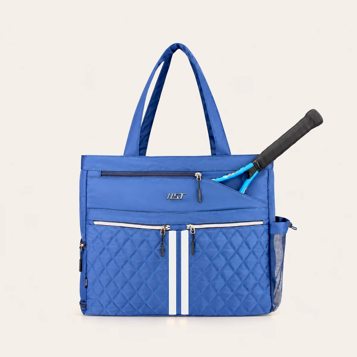 Front racket position on a blue NST tennis tote with one racket handle exposed